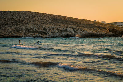 Scenic view of sea against clear sky during sunset