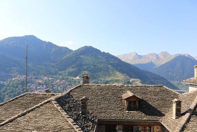 Houses on mountain against sky