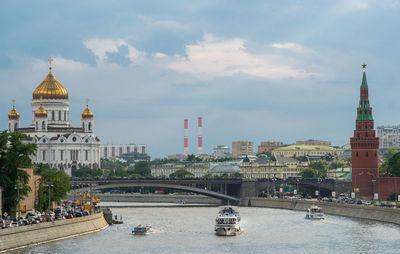 View of cityscape against cloudy sky