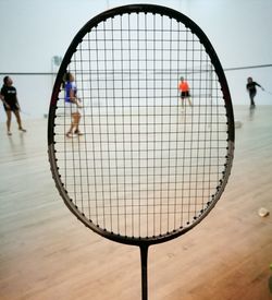 People seen through badminton racket