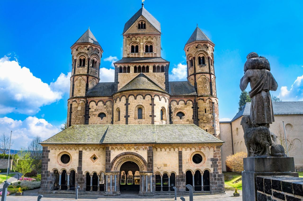 travel destinations, sky, architecture, tower, religion, blue, built structure, clock tower, outdoors, place of worship, building exterior, city, no people, clock, tree, day