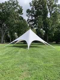 Tent on field against trees