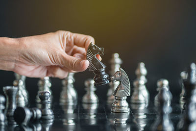 Cropped hand playing chess 