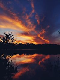 Scenic view of lake against romantic sky at sunset