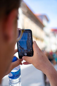 Close-up of man photographing through camera