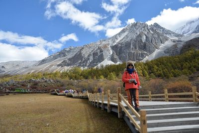 Woman walking on staircase against mountains and sky