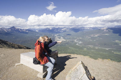 Man photographing against sky