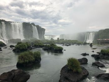 Scenic view of waterfall against sky