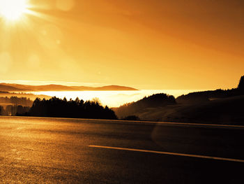 Scenic view of road against sky during sunset