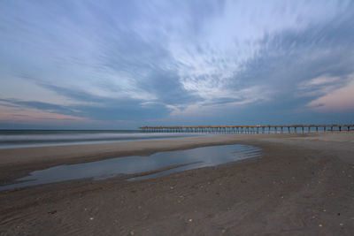 Scenic view of beach against sky during sunset