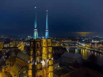 High angle view of illuminated buildings in city at night