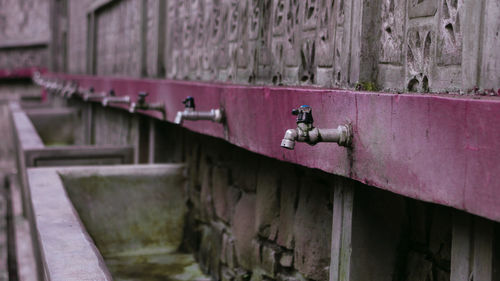 Close-up of old rusty mounted on wall