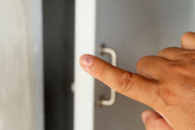 Close-up of hand holding open door