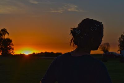 Portrait of silhouette man standing on field against sky during sunset