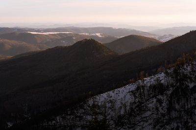 Scenic view of snowcapped mountains against sky during sunset