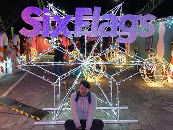 Full length of woman in amusement park ride at night