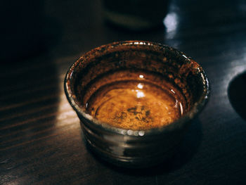 High angle view of wet container on wooden table