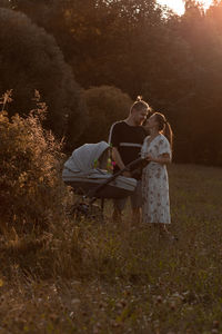 Couple on field by trees