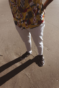 Low section of woman standing on street