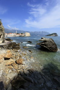 Rocks on sea shore against sky