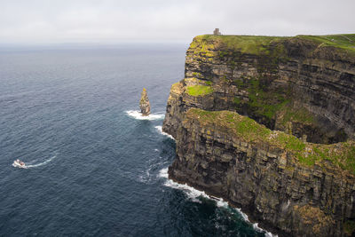 Rock formations by sea against sky