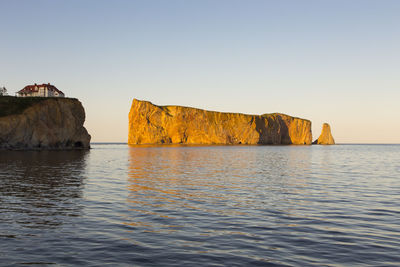 A percé village cliff and famous rock seen during a beautiful sunny summer late afternoon
