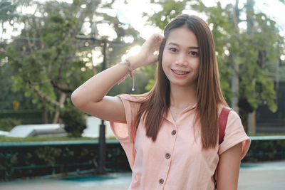 Portrait of smiling young woman in swimming pool