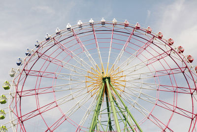 Low angle view of ferris wheel against sky