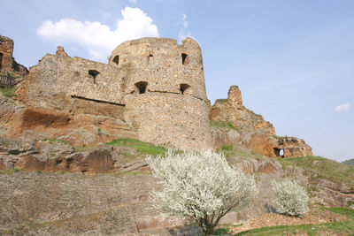 Low angle view of old ruin building against sky