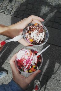 Low section of woman holding ice cream in bowl