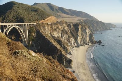 Scenic view of sea and mountains against sky big sur bridge with pacific ocean