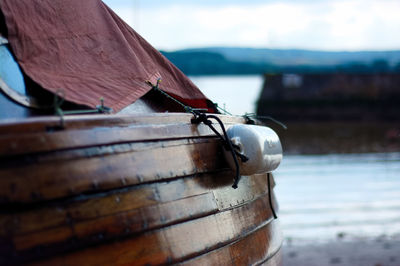 Close-up of rope on wood against sky