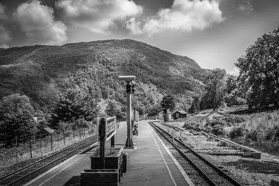 Railroad tracks amidst trees against sky