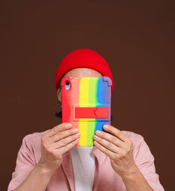 Cropped hand of woman holding toy against black background