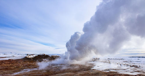 Scenic view of geyser against sky