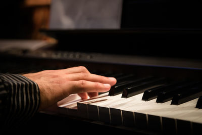 Close-up of hands playing the piano