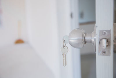 Close-up of key on door knob