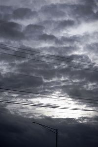 Low angle view of silhouette birds flying in sky