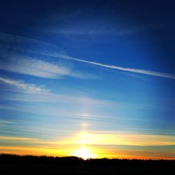 Silhouette landscape against blue sky