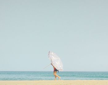 Rear view of man standing on beach