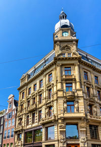 Low angle view of old building against blue sky