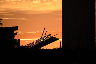 Low angle view of silhouette buildings against sky during sunset
