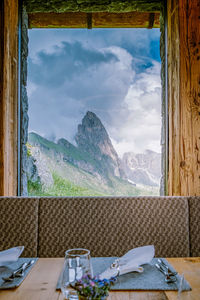 Scenic view of mountains against sky seen through window