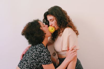 Mother and daughter against white background