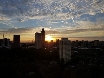 Silhouette buildings against sky during sunset