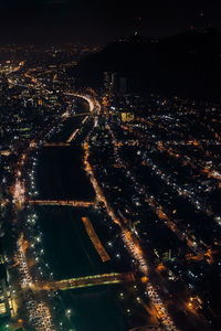 High angle view of illuminated city buildings at night