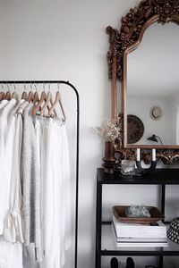 Clothes hanging on rack against wall at home