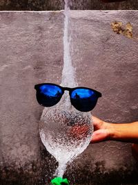 Close-up of hand holding glass of water