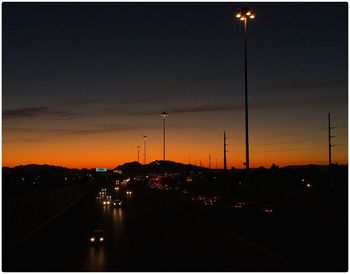 Silhouette road against sky at night