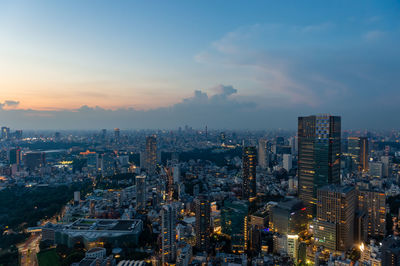 High angle view of illuminated buildings in city against sky